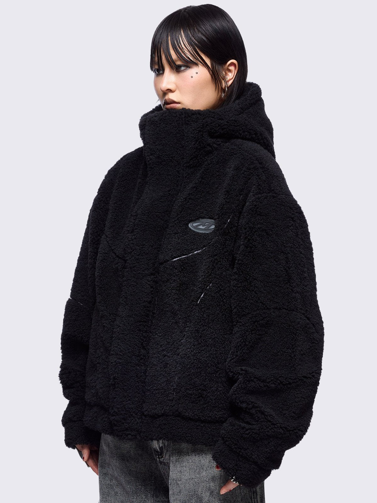 Black fleece hoodie jacket featuring grey piping and high neck hood.