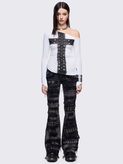 Black washed flare jeans featuring heavy distressed and shedded, eyelet, piercing and stud details. 