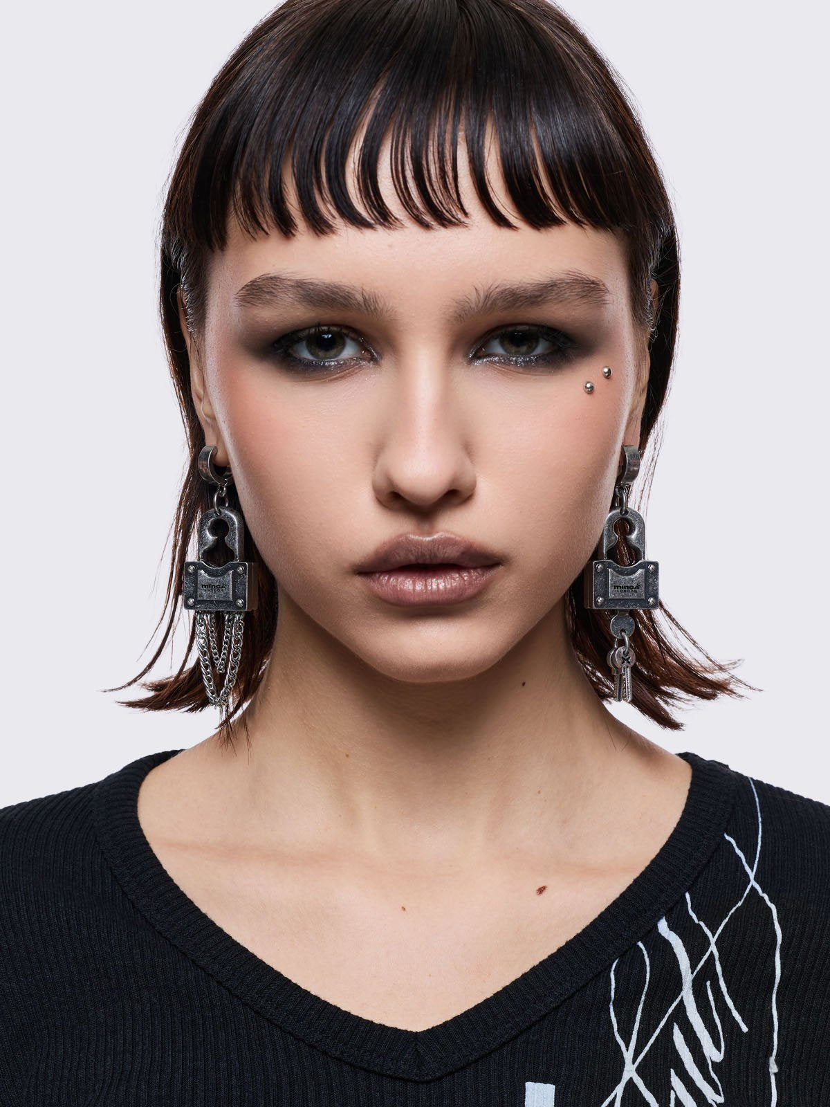 Chunky silver padlock pendant hoop earrings.