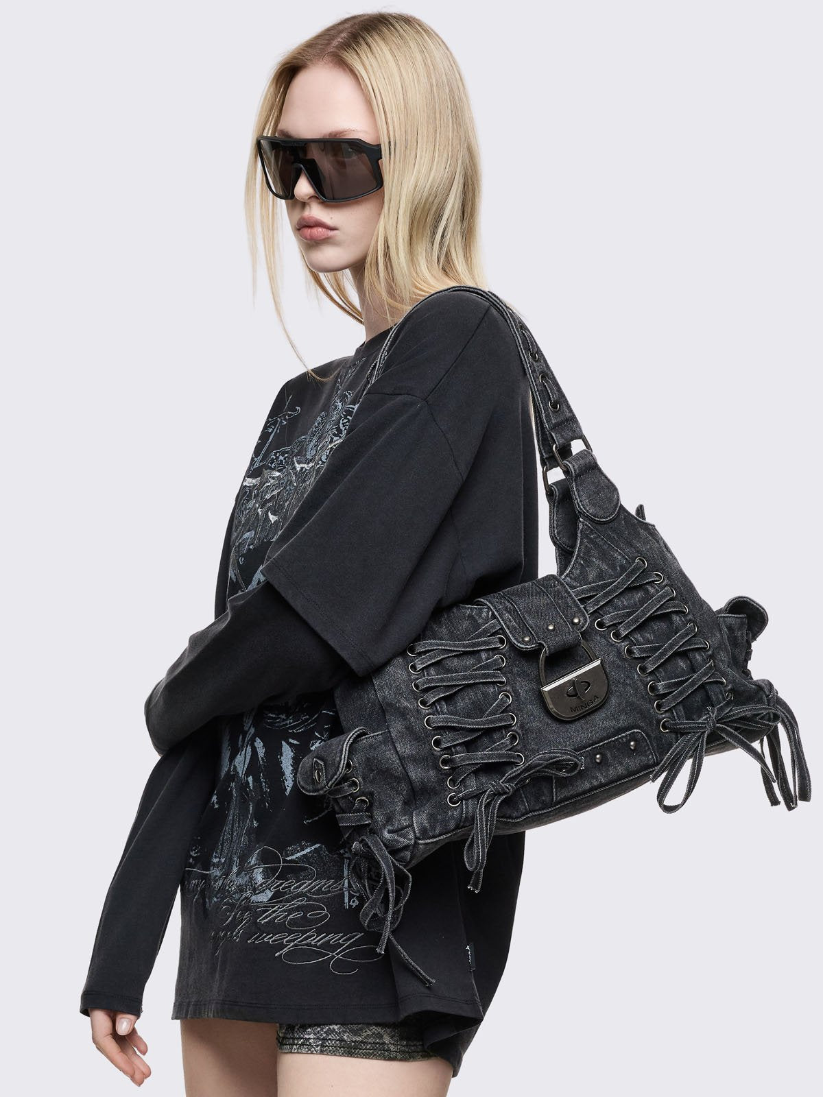 Lace-up shoulder bag in black washed denim. 