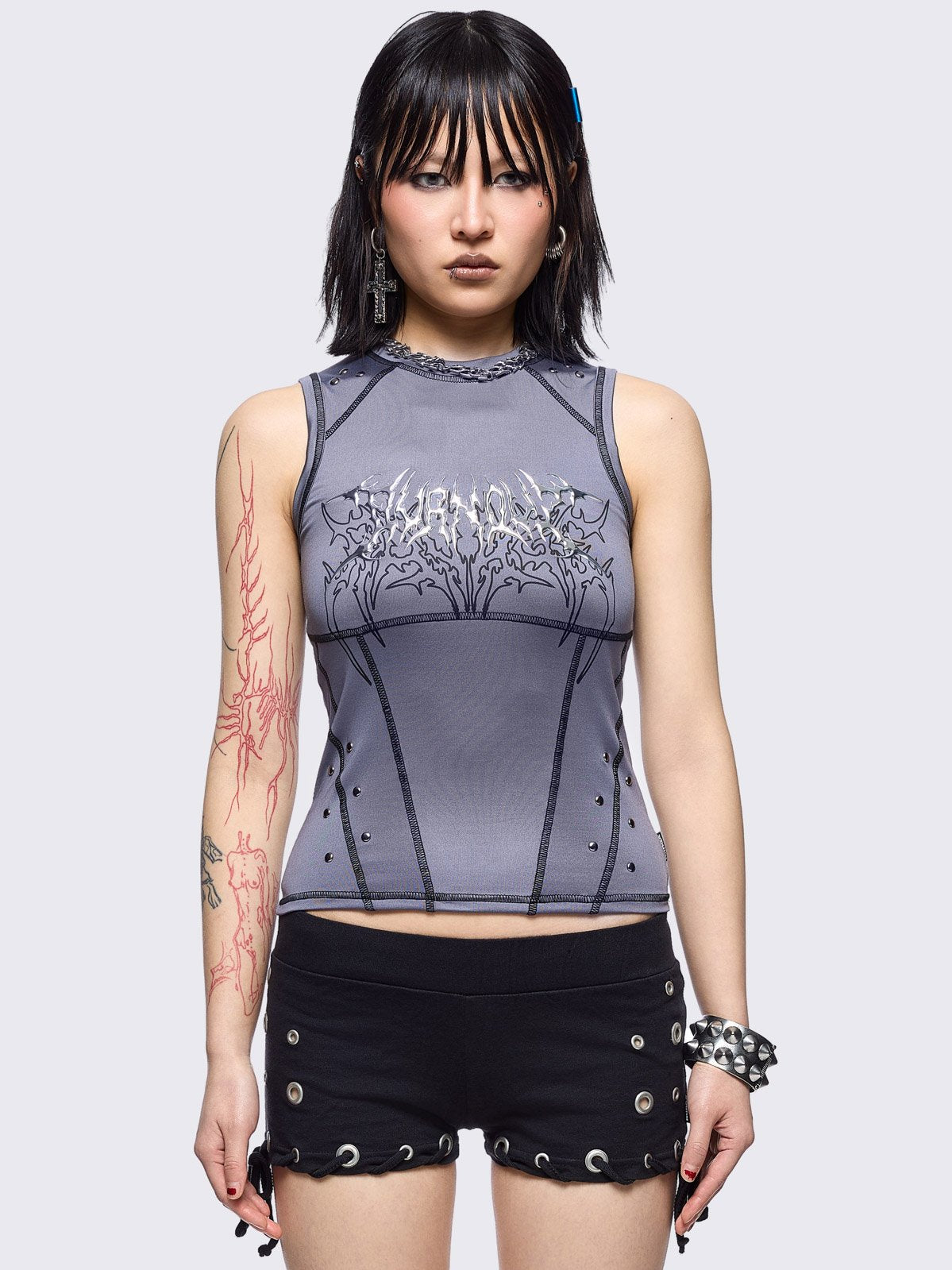 Grey vest top with metal embossed and black sigilism graphic print, stud details and black contrast stitching.