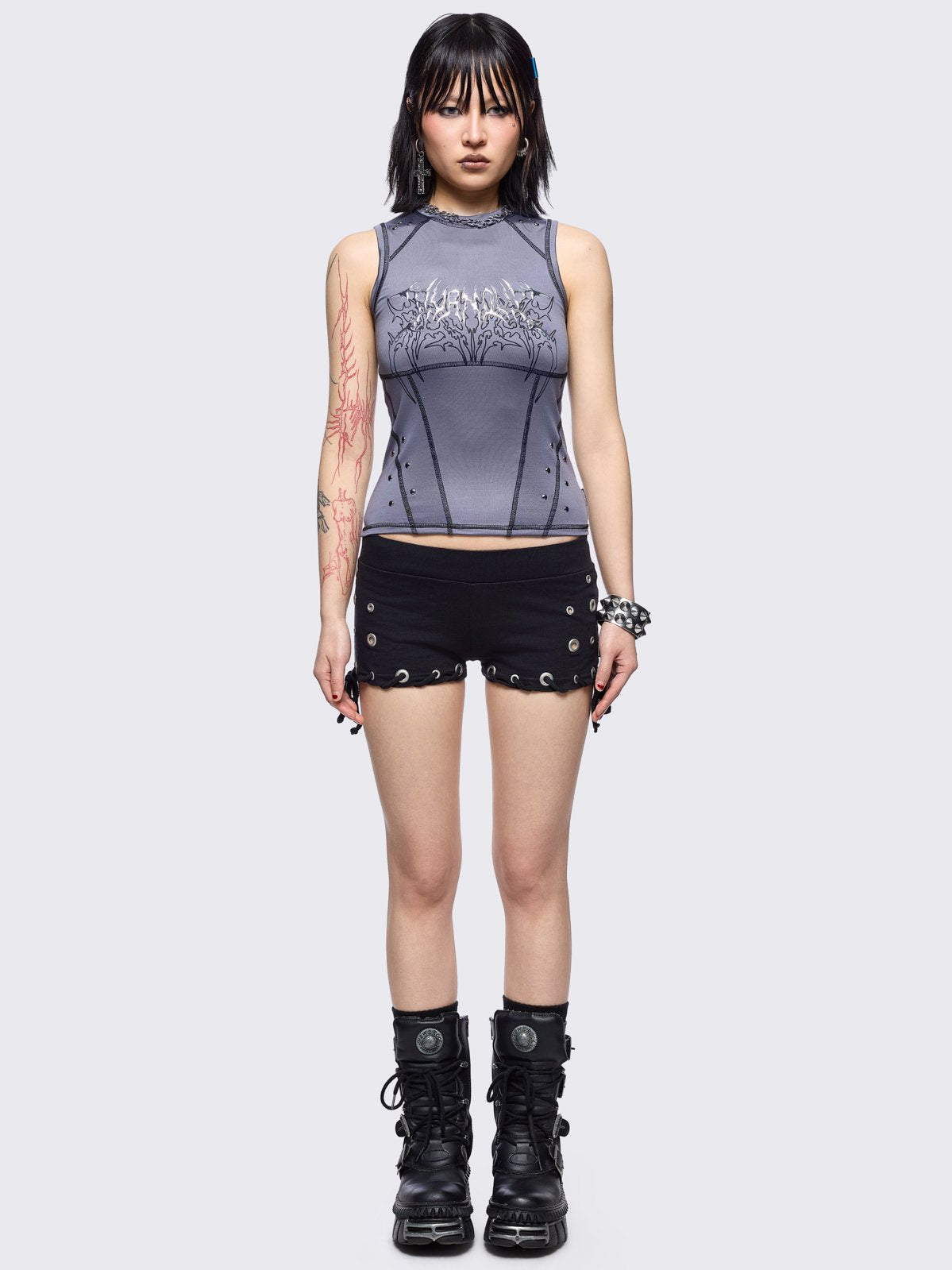 Grey vest top with metal embossed and black sigilism graphic print, stud details and black contrast stitching.