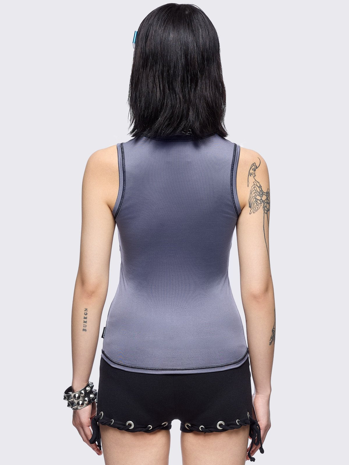 Grey vest top with metal embossed and black sigilism graphic print, stud details and black contrast stitching.