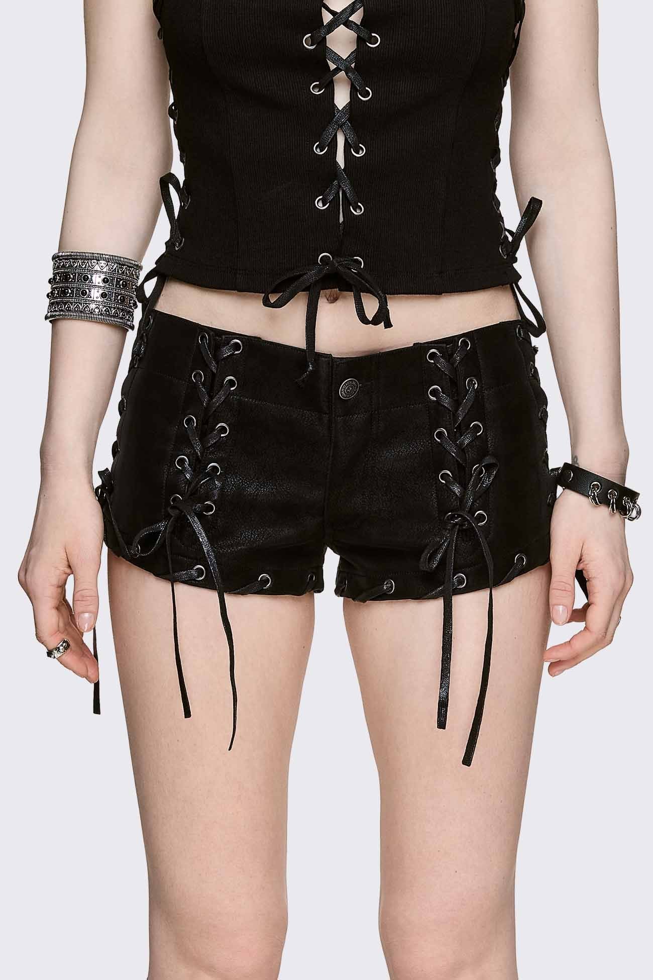 Black vegan suede micro shorts with front and side lace-up details, low-rise fit in a grunge goth style.