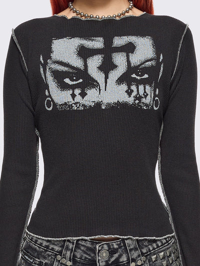 Black ribbed long sleeve top featuring a malefic eyes graphic front print, thumbhole cuffs and white reverse stitching. 