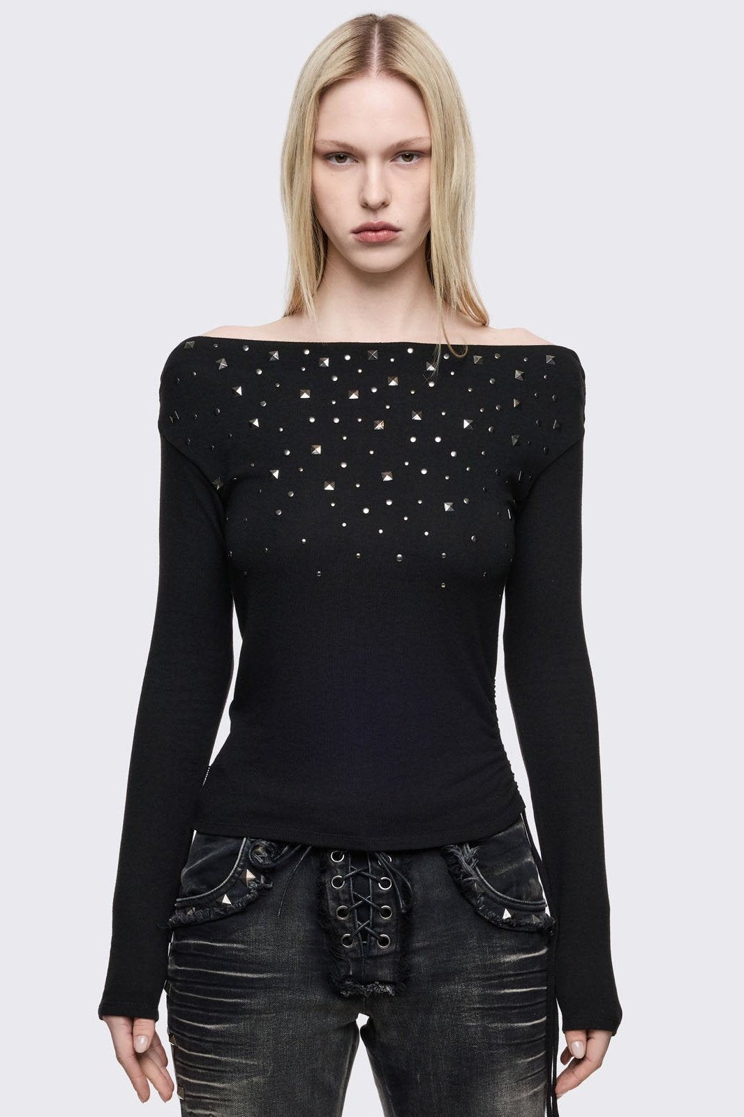 Black long sleeve top with stud details and off-shoulder style.