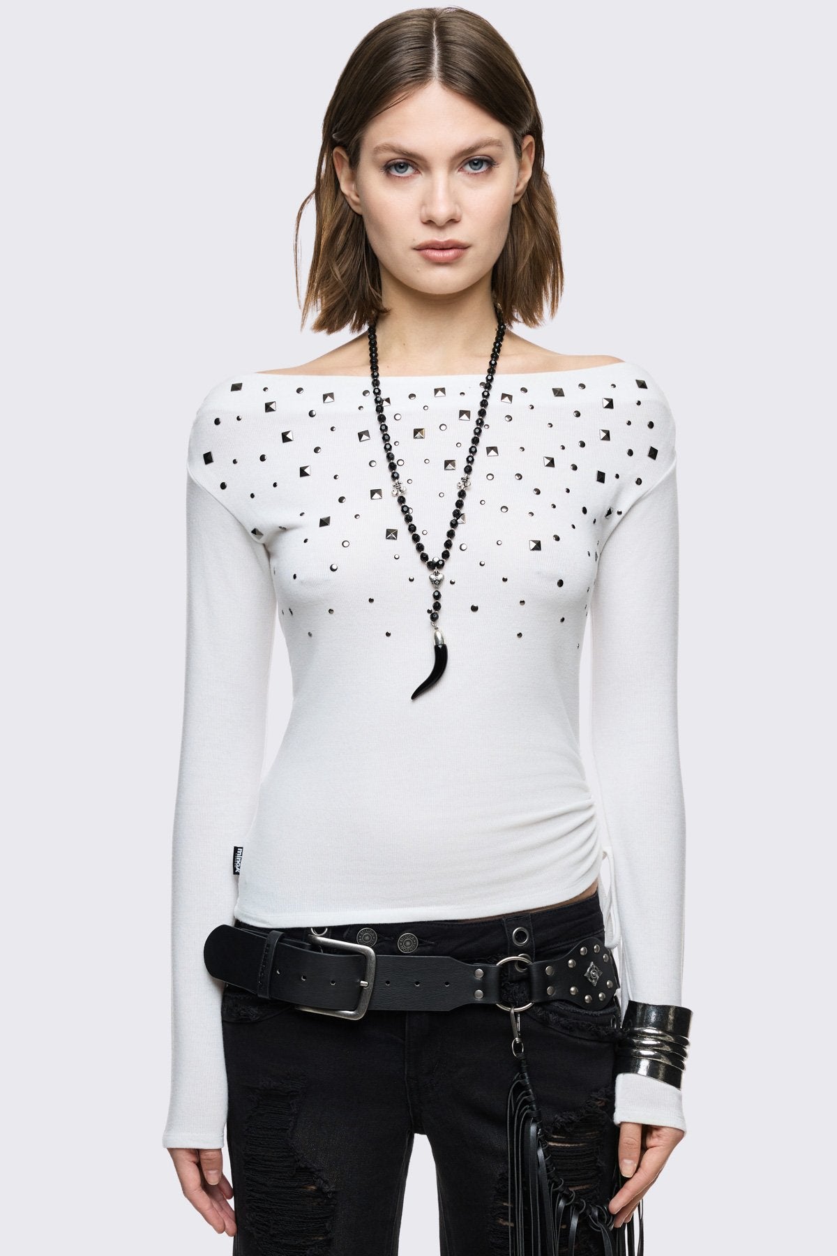 White off-shoulder long sleeve top and stud details.  