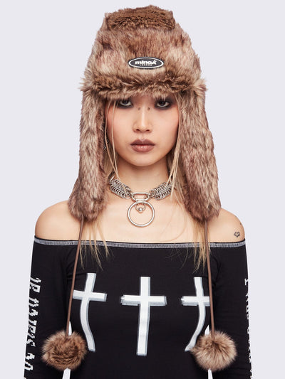 Beige faux fur trapper hat with minga rubber logo detail and ear flaps