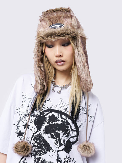 Beige faux fur trapper hat with minga rubber logo detail and ear flaps