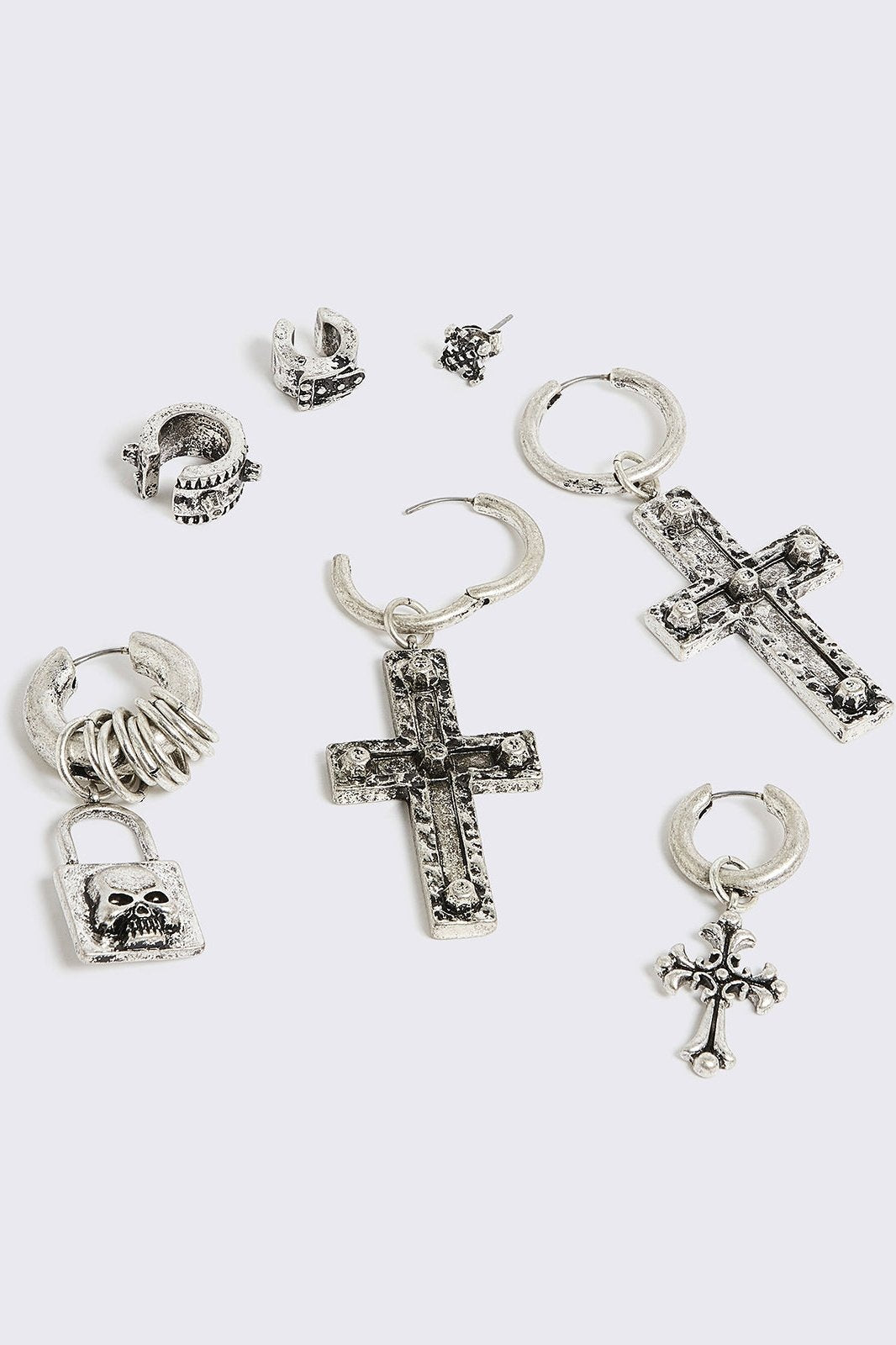 Silver 7pc earring set featuring cross pendants and more styles.