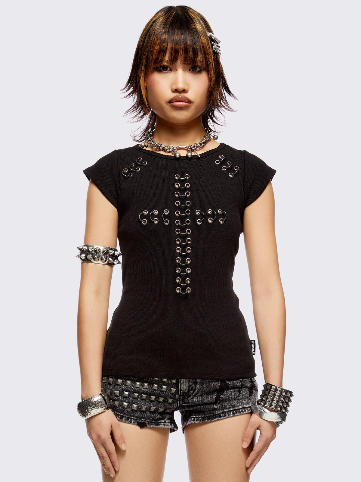 Black baby tee with pierced silver cross. Grunge goth vibes. 