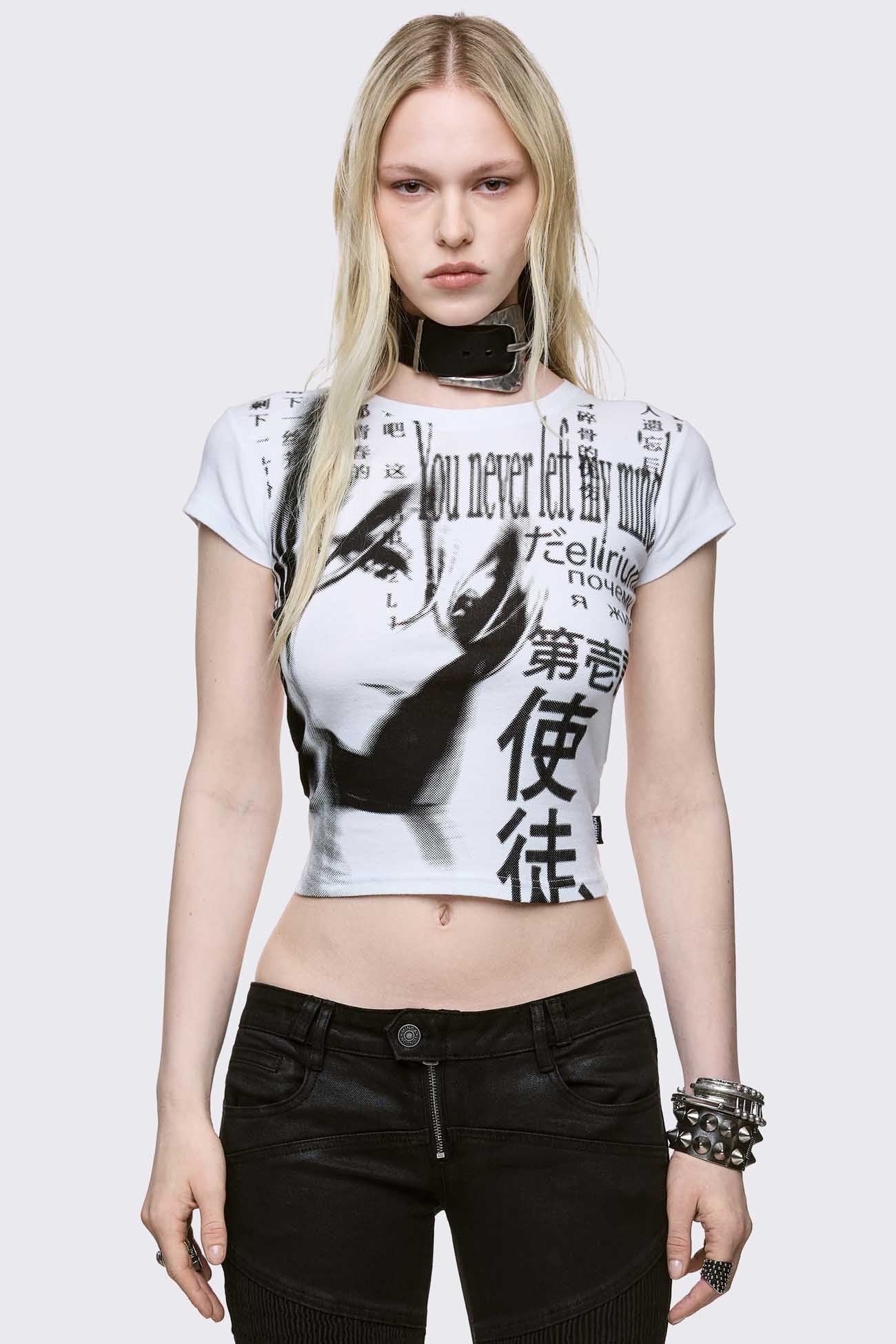 A fitted white baby tee featuring a large black monochrome graphic of a manga-style girl's face mixed with Japanese kanji and English text.