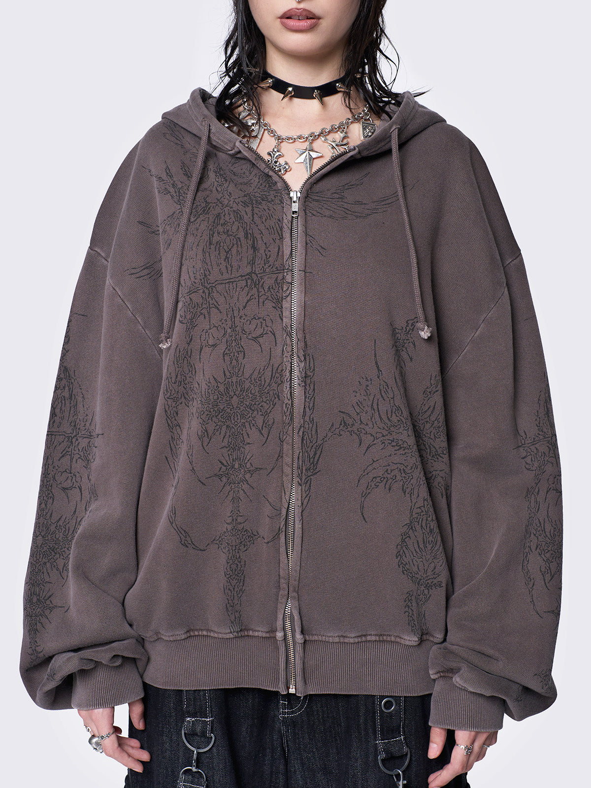 Washed brown zip-up hoodie jacket with grunge graphic prints on the front and sleeves.