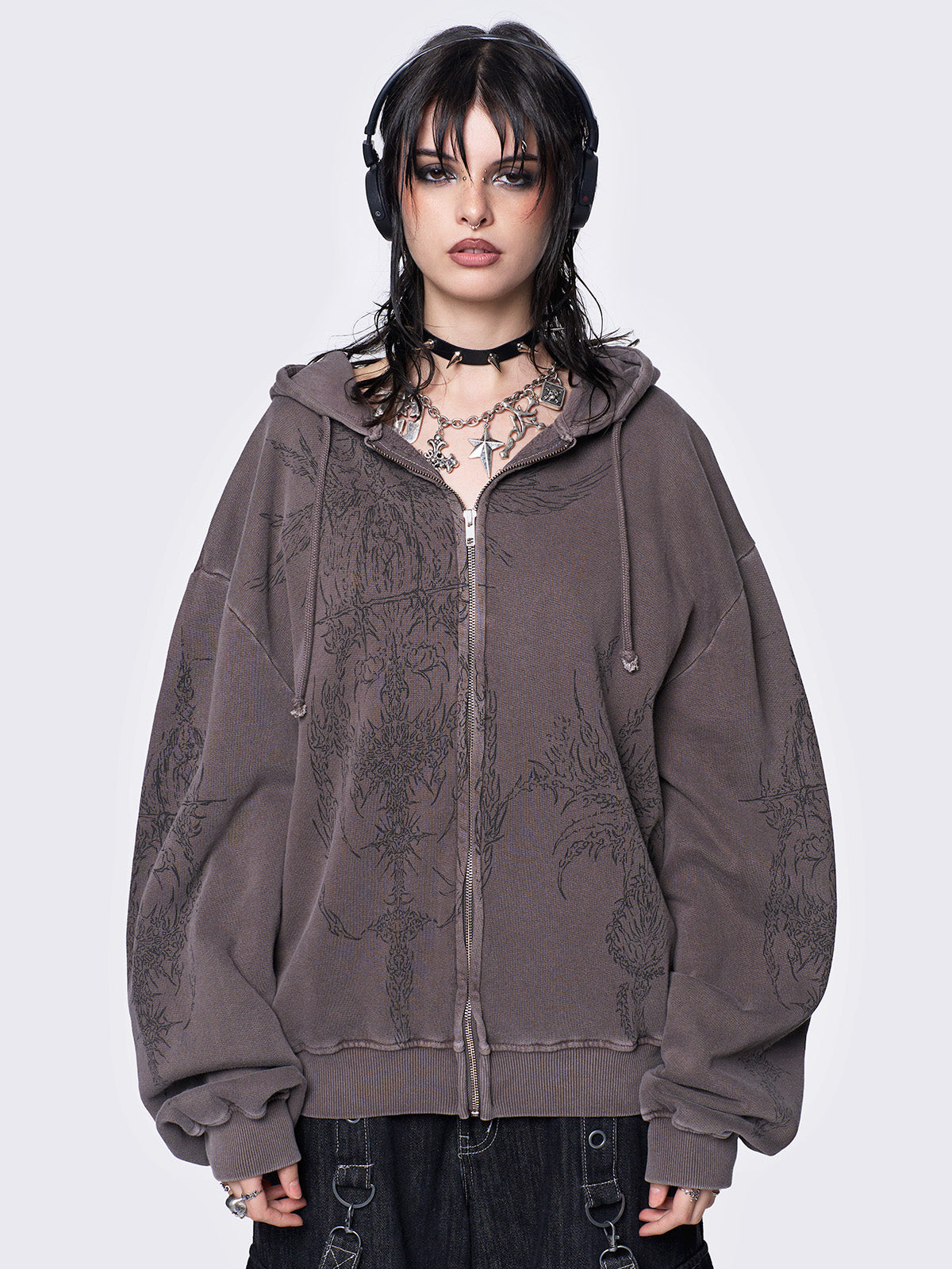 Washed brown zip-up hoodie jacket with grunge graphic prints on the front and sleeves.