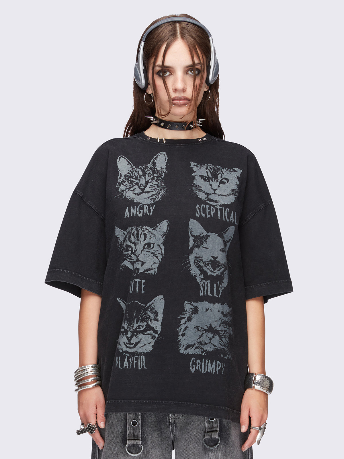 Black washed oversized t-shirt with kitty's mood graphic front print and eyelet and spike neckline details.