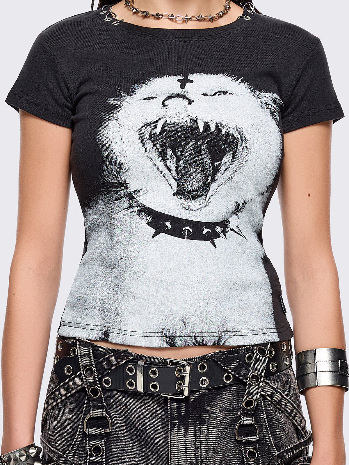 Black graphic baby tee with goth cat graphic print and piercing O-ring details on neckline.