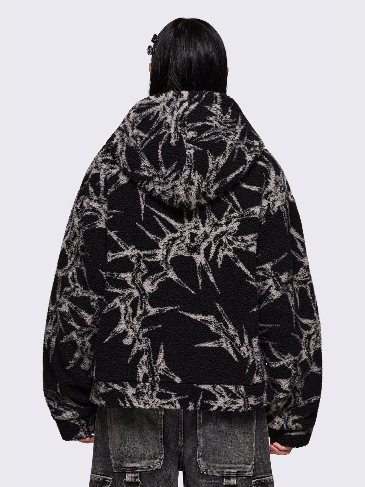 Black fleece borg hoodie jacket featuring all over grey thorns design.