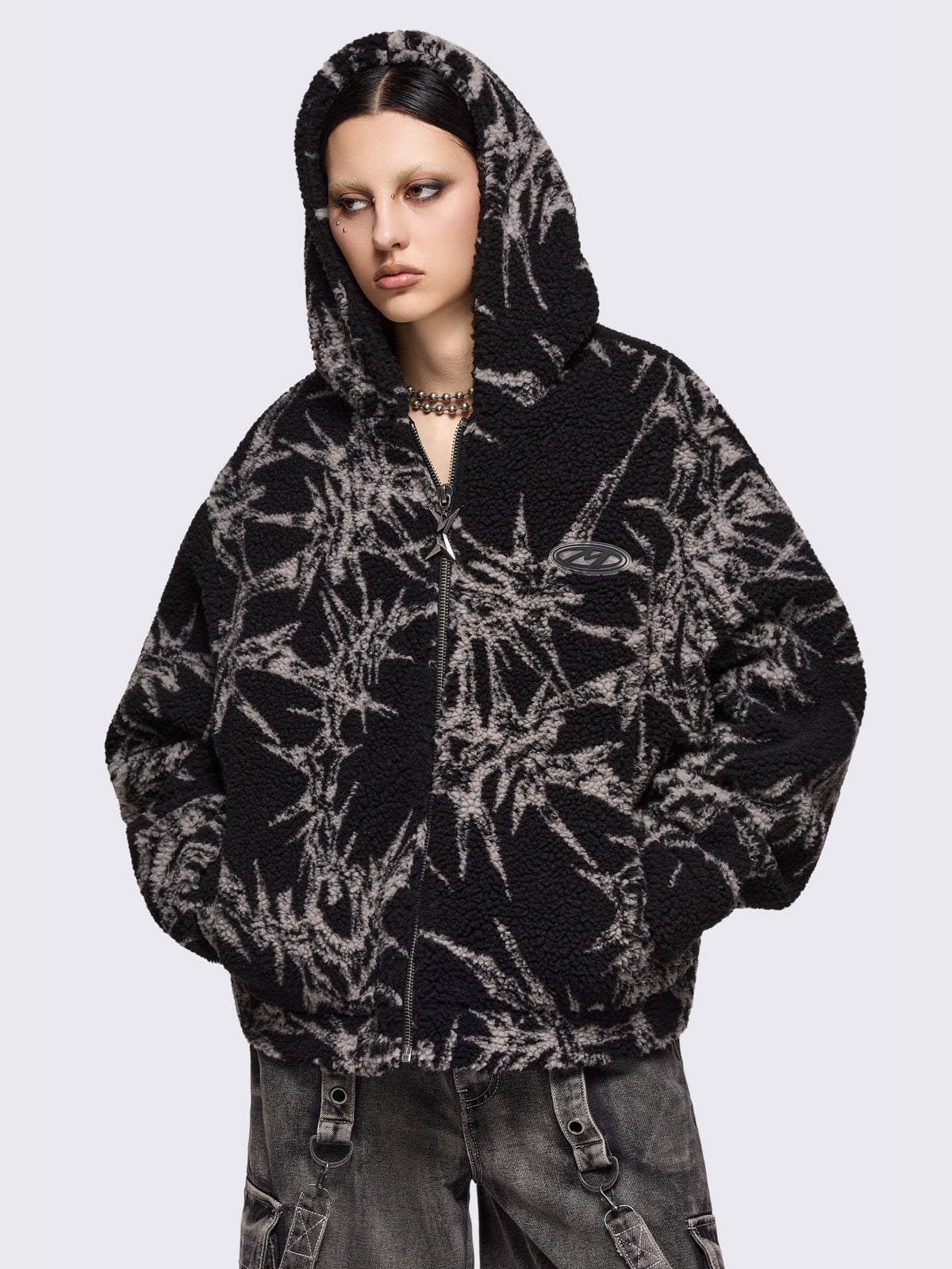 Black fleece borg hoodie jacket featuring all over grey thorns design.