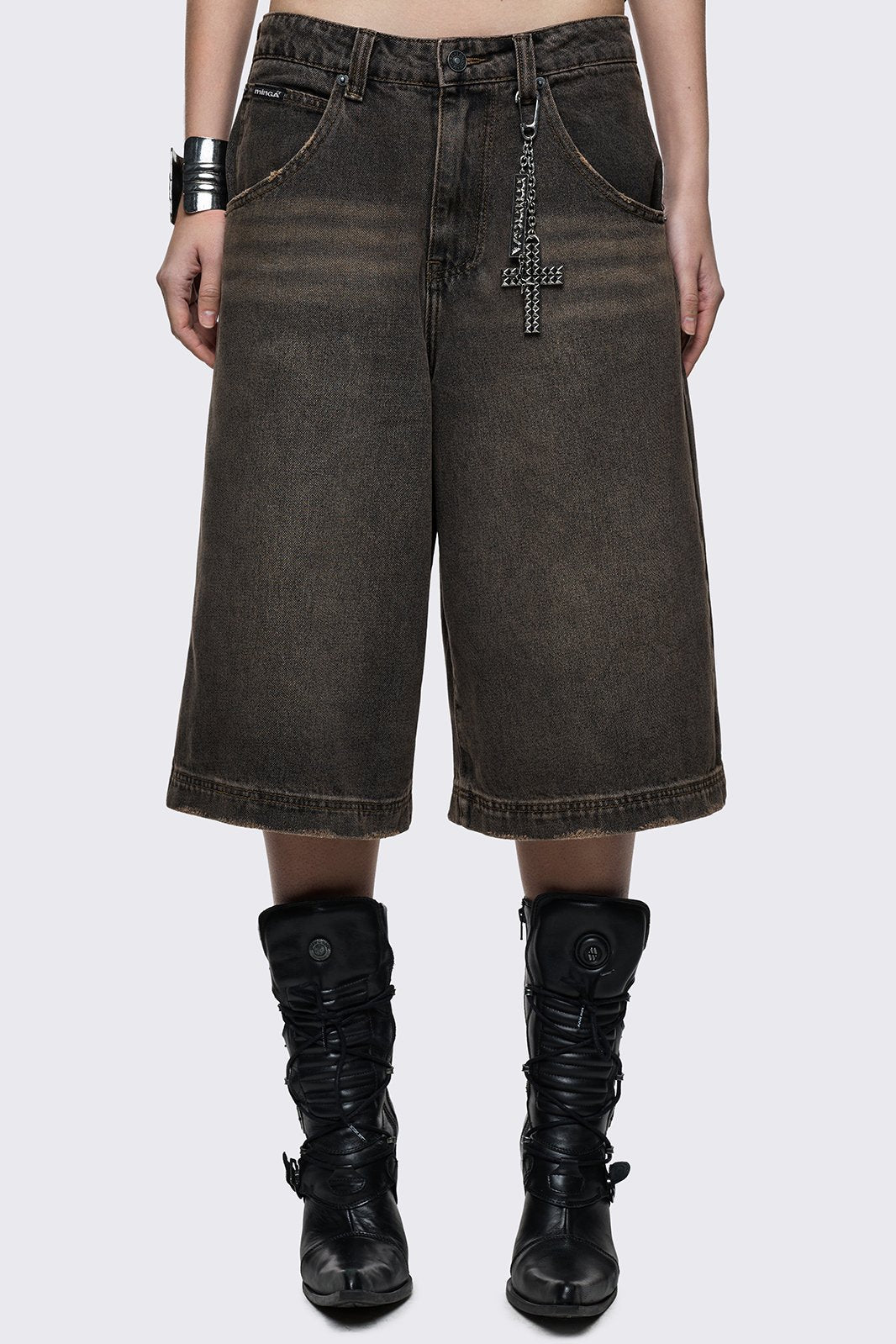 Black washed longline denim shorts with brown overdye and removable chain with cross. 