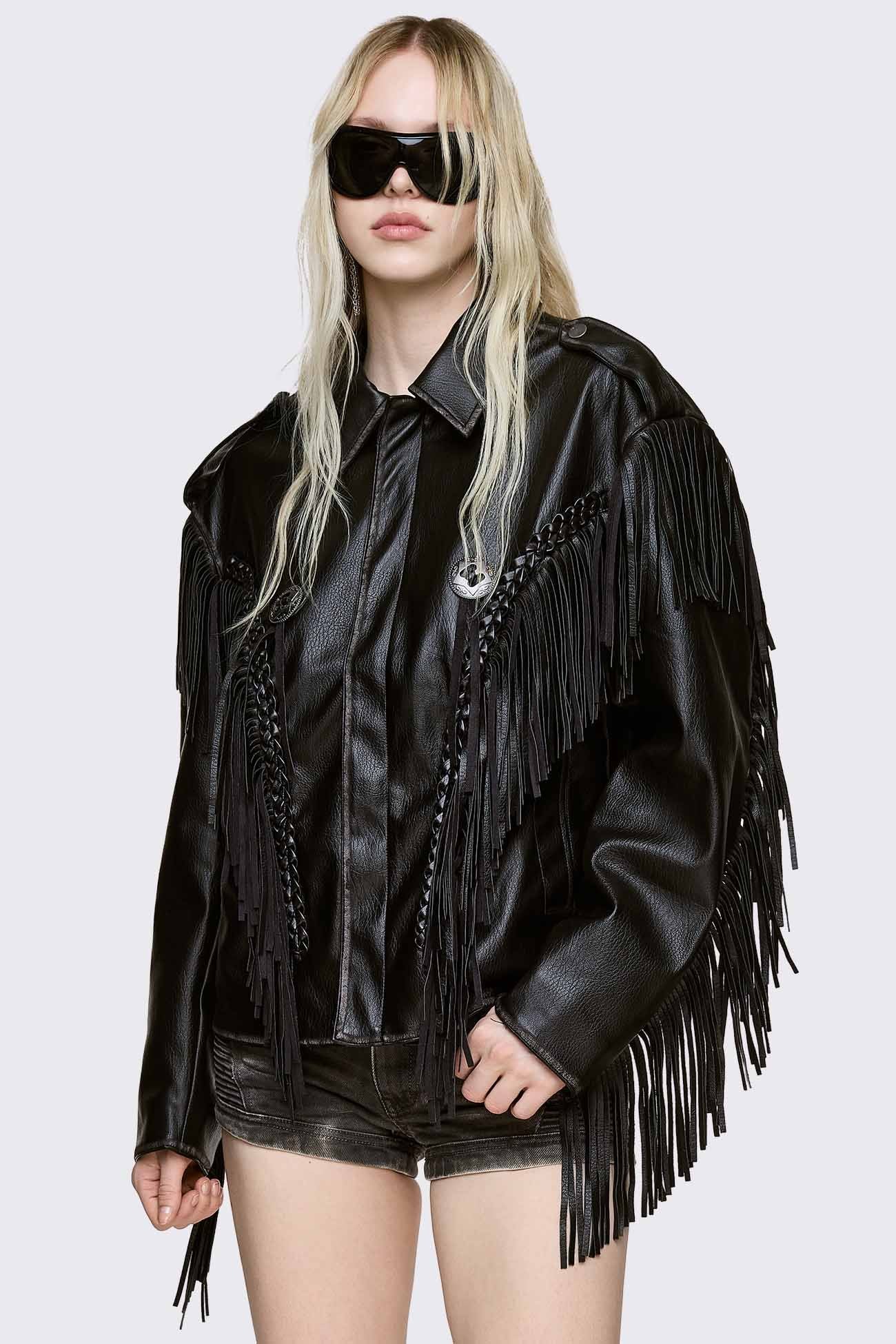 Black faux leather jacket with fringe, braided trim, and button details in a grunge biker style.