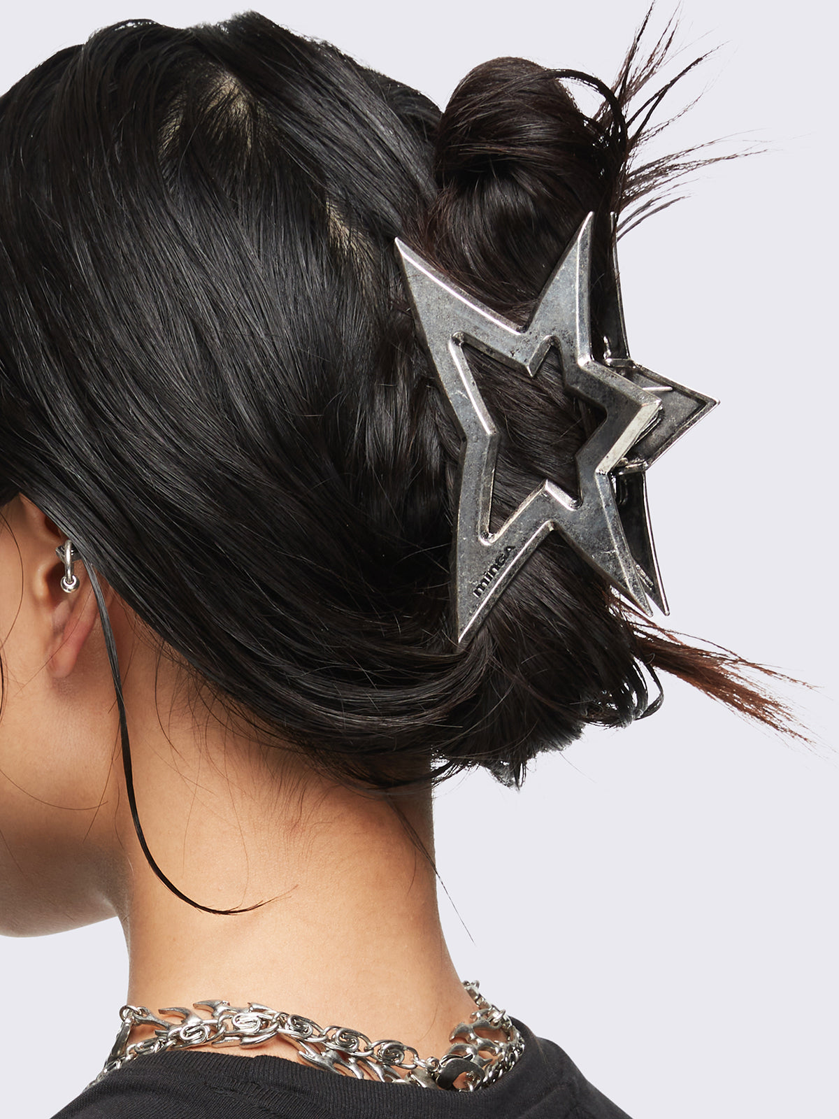 Metal hair claw clip featuring a star design.