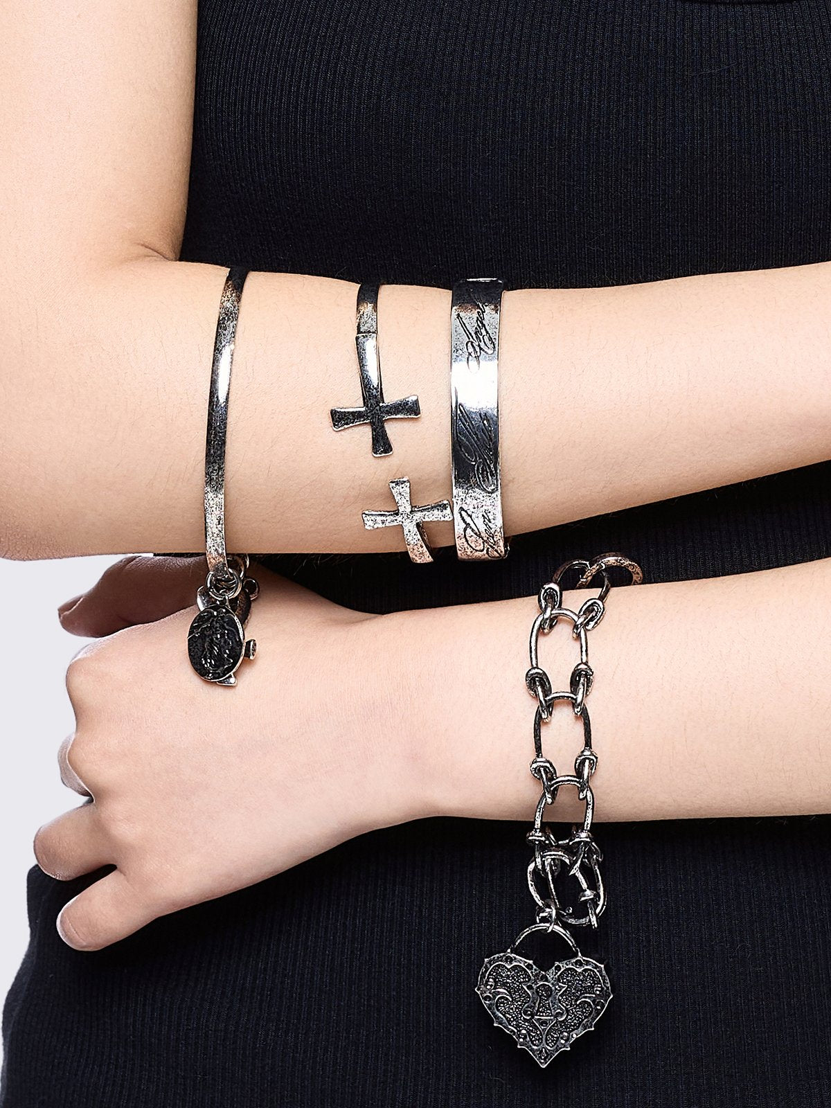 Set of 4 bracelets with cross design and heart pendants