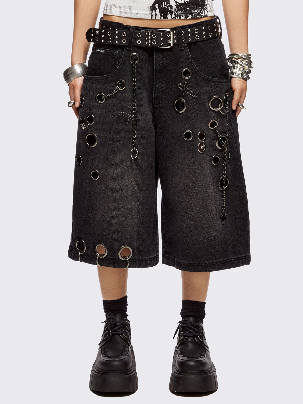 Black washed longline denim shorts with eyelets, chains, safety pins and more metal hardware details. Streetwear, grunge and y2k vibes.