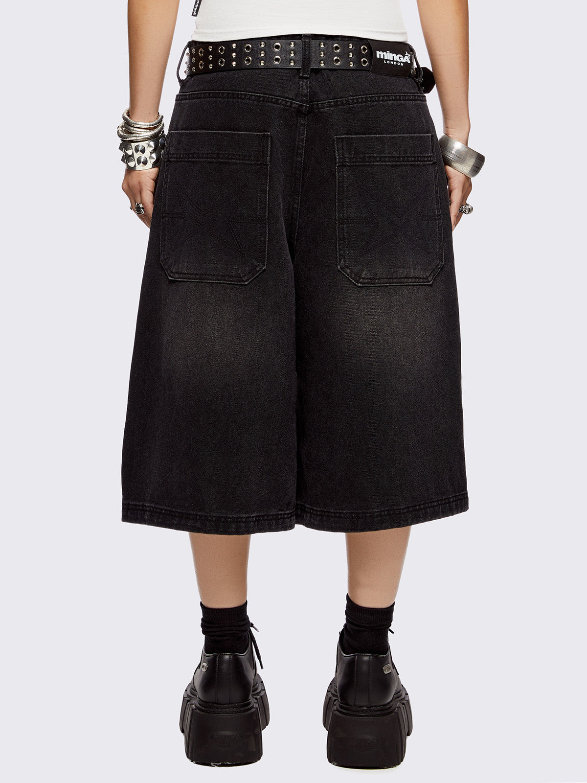 Black washed longline denim shorts with eyelets, chains, safety pins and more metal hardware details. Streetwear, grunge and y2k vibes.