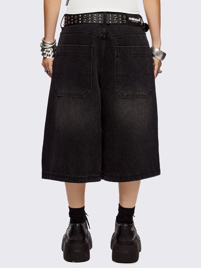 Black washed longline denim shorts with eyelets, chains, safety pins and more metal hardware details. Streetwear, grunge and y2k vibes.
