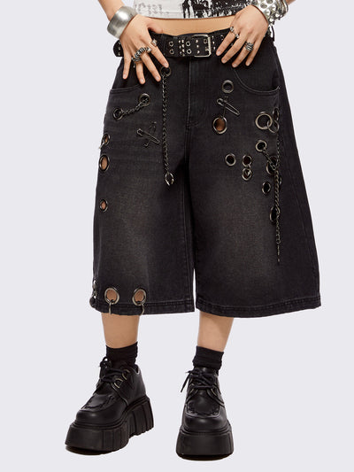 Black washed longline denim shorts with eyelets, chains, safety pins and more metal hardware details. Streetwear, grunge and y2k vibes.