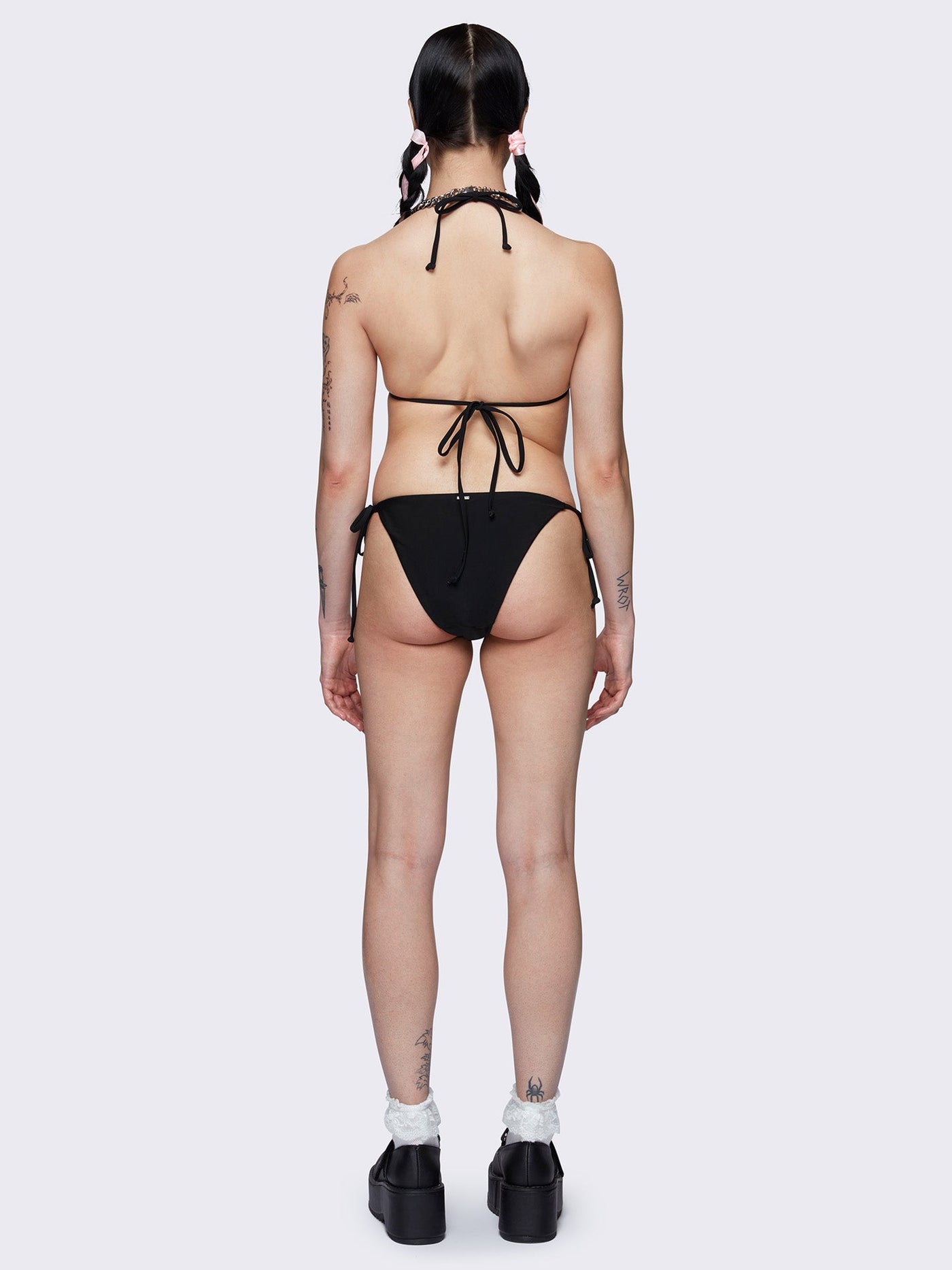 Halter neck triangle bikini top in black with contrast lace up in white and bow details in pink