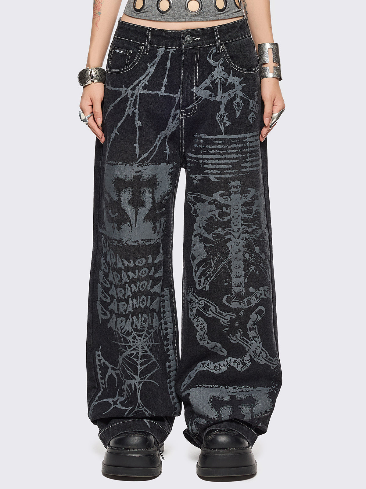 Black baggy wide leg jeans featuring a multi grunge graphic prints with white contrast stitching.