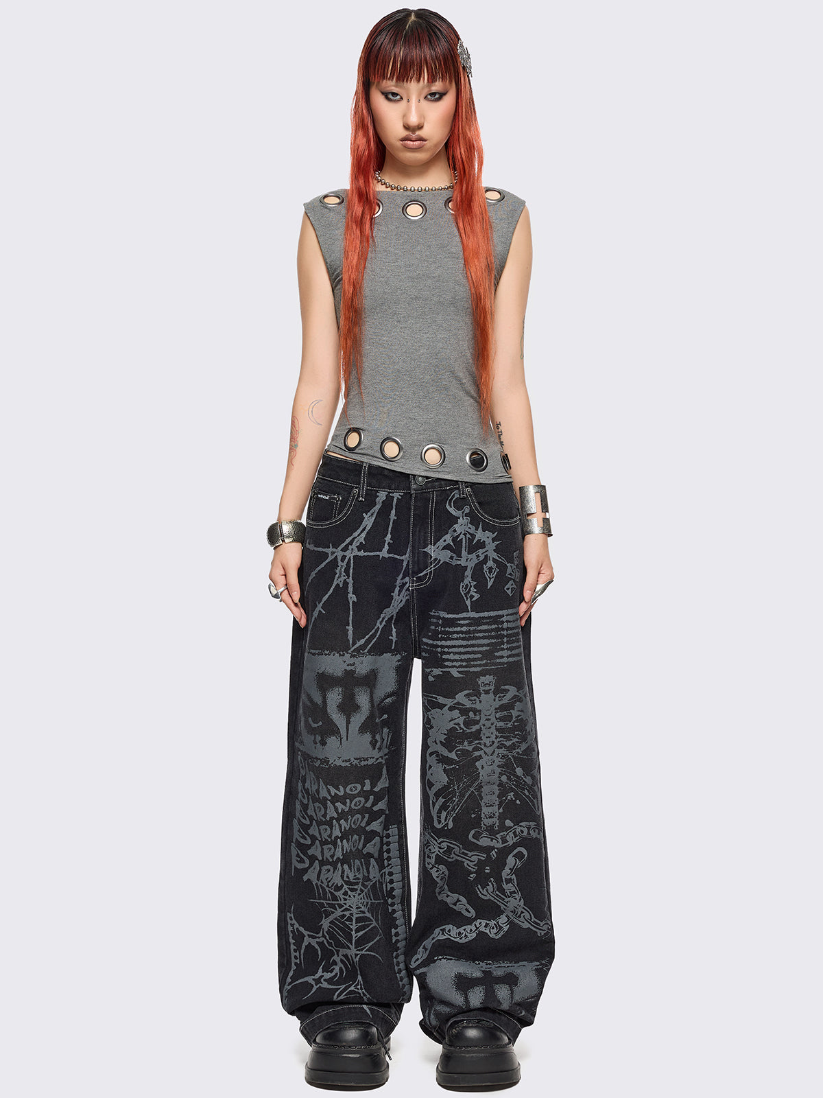 Black baggy wide leg jeans featuring a multi grunge graphic prints with white contrast stitching.
