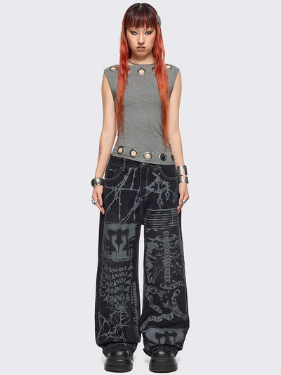 Black baggy wide leg jeans featuring a multi grunge graphic prints with white contrast stitching.