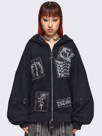 Black zip up hoodie jacket with white grunge print patches and eyelets with O-ring and piercing details.