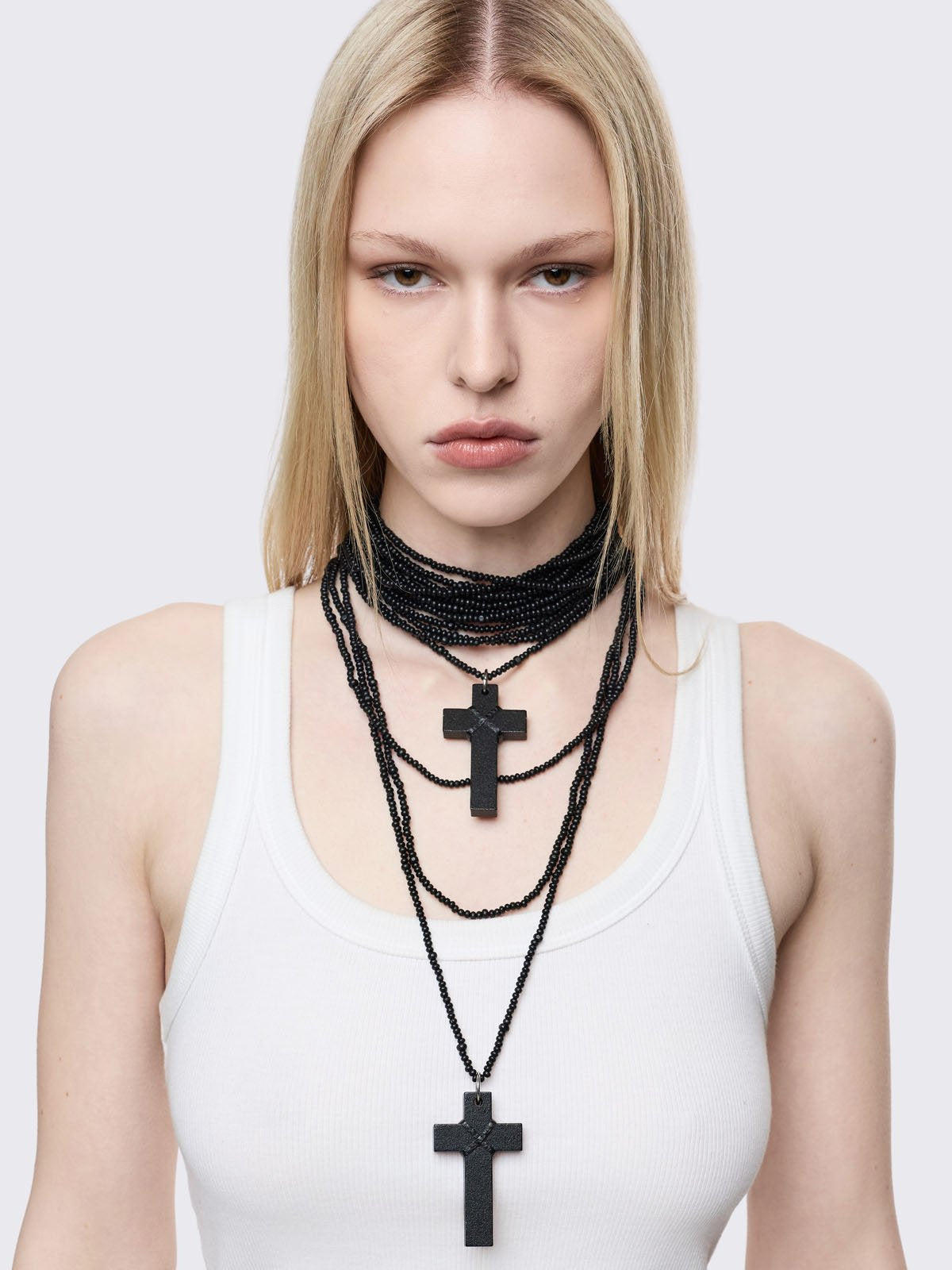 Black multi-layered beaded necklace with cross pendants