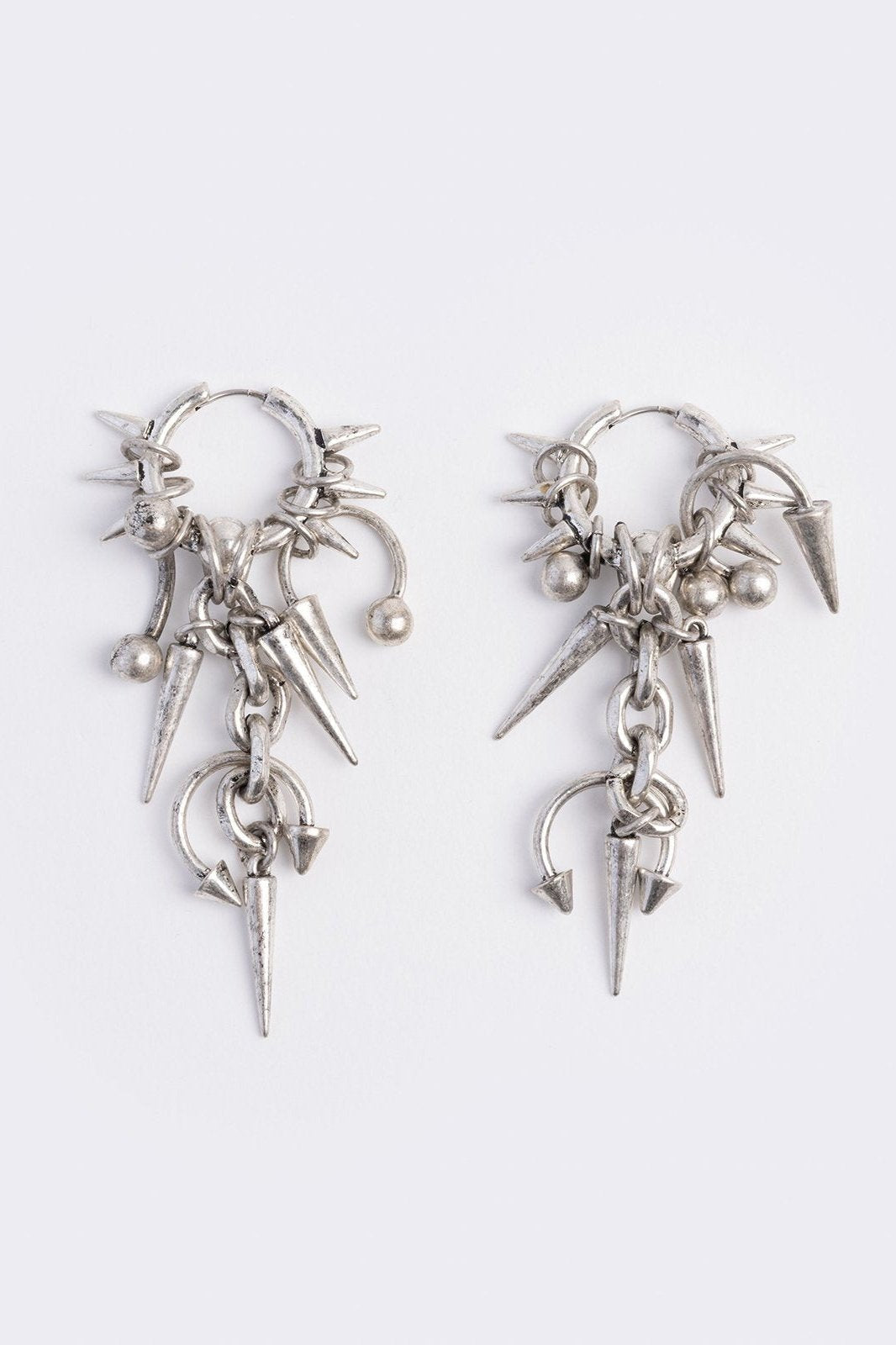 Silver chunky hoop earring with spike and piercing pendants.