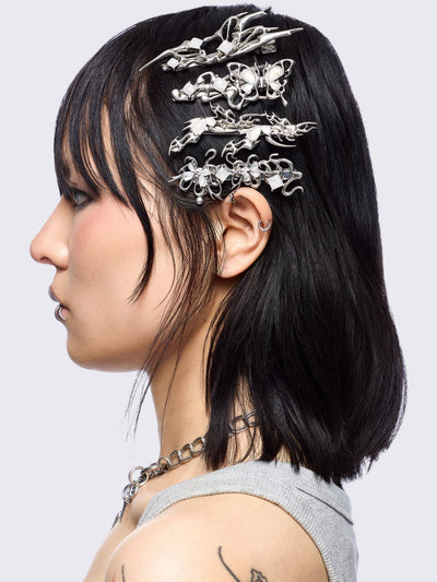 Set of 4 hair clips with butterflies and sigilism design and white stone details.