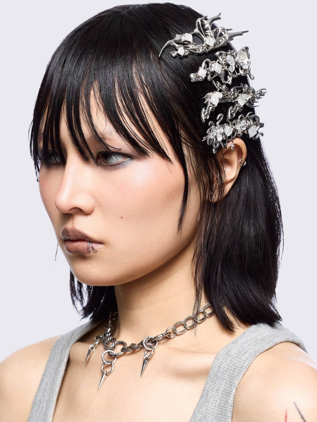 Set of 4 hair clips with butterflies and sigilism design and white stone details.