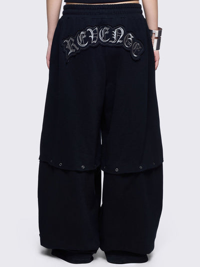 Black sweatpants with silver studded cross, "Reverse" patch back and detachable-leg .