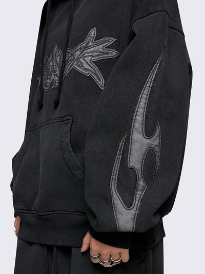 Black washed hoodie with grey sigilism embroidered patches, drawstring hood, and kangaroo pockets