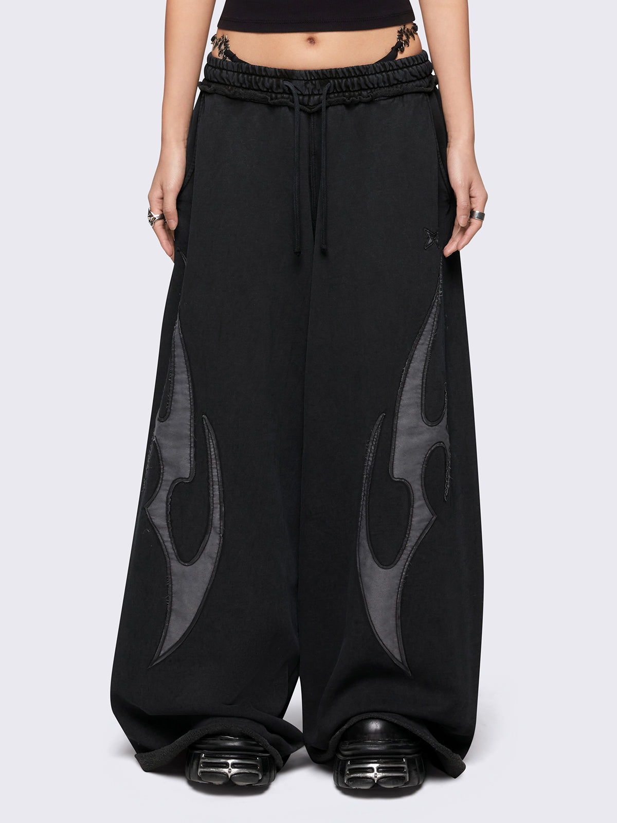 Black washed wide leg sweatpants with grey sigilism patches.