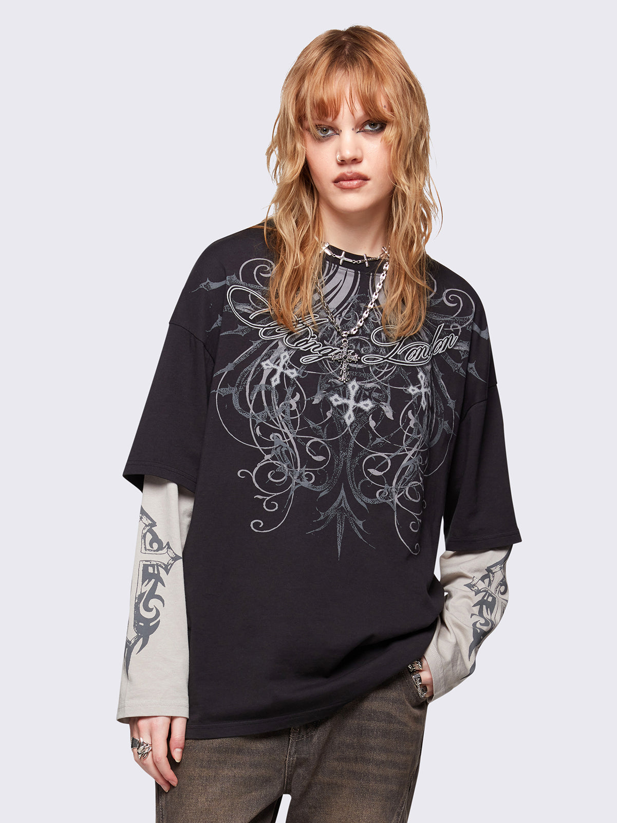 Black layered long sleeve t-shirt with grunge graphic front print and off-white contrast sleeves with cross print. Relaxed fit and crew neck.