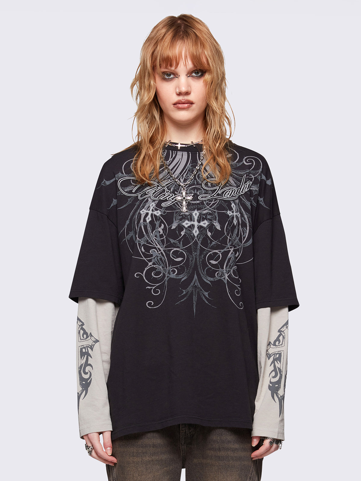 Black layered long sleeve t-shirt with grunge graphic front print and off-white contrast sleeves with cross print. Relaxed fit and crew neck.