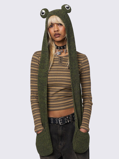 Knitted hooded scarf in green featuring a beanie-style hood with frog eyes and pockets at the scarf end.