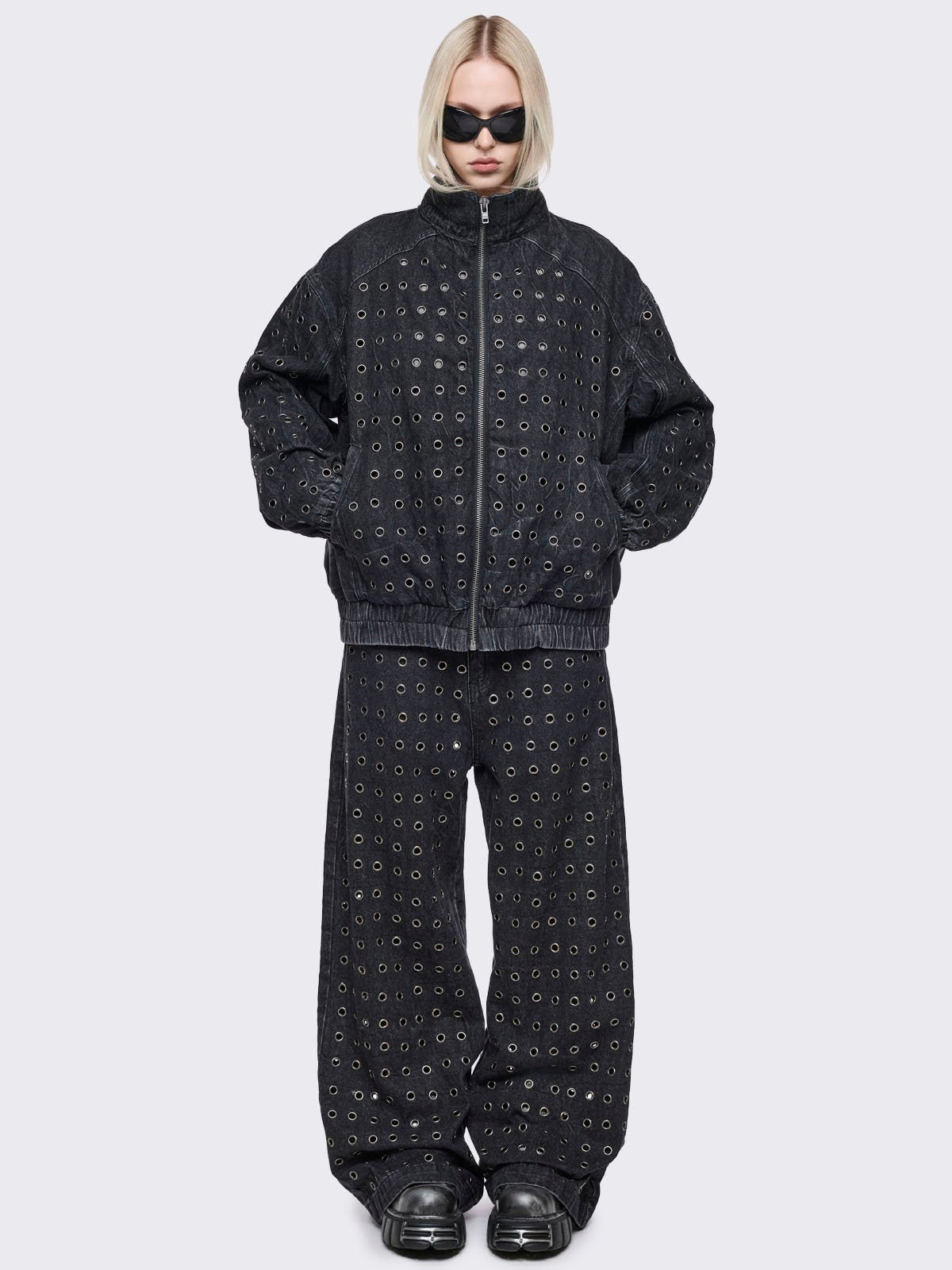 Black washed denim oversize bomber jacket with silver eyelets and seam details. 