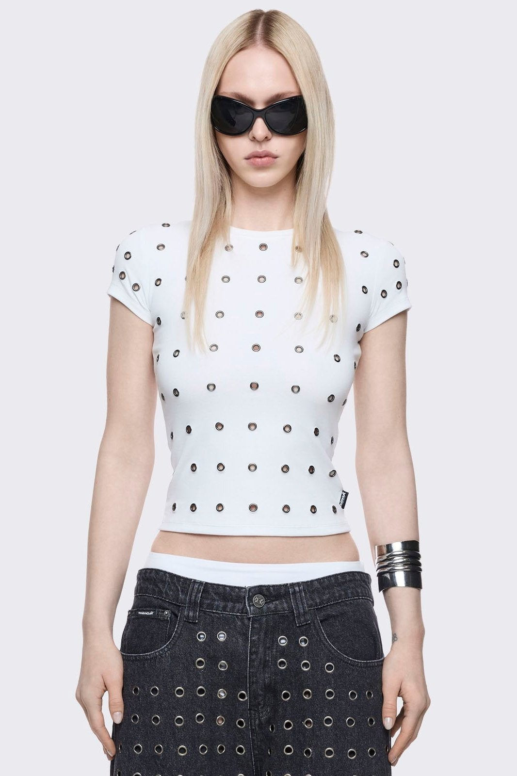 White baby tee with silver eyelets. 