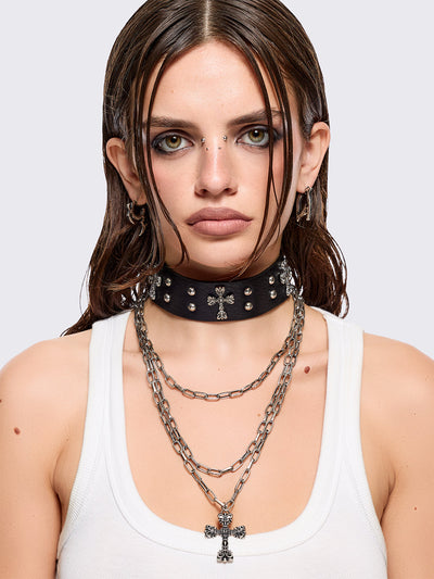 Set of 2 necklaces: One black PU choker with crosses and studs and other silver multiple chain with cross pendant.