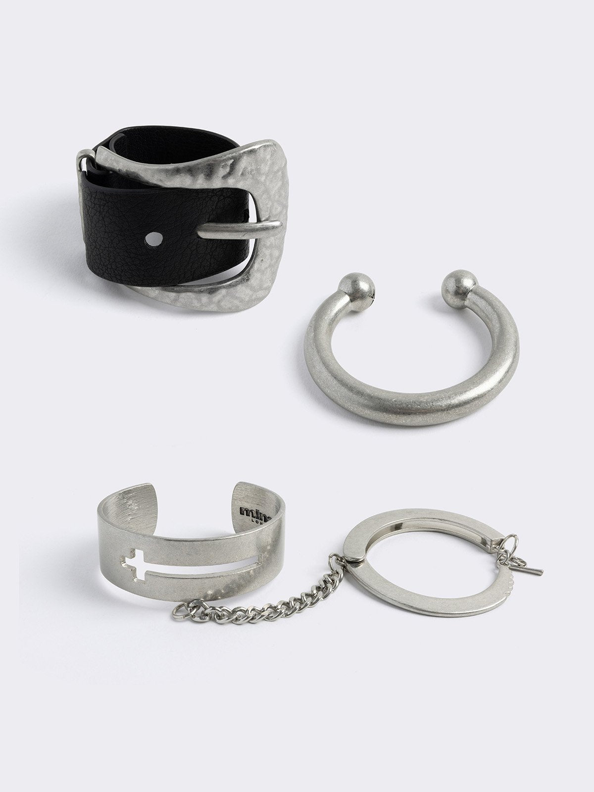 Set of 3 bracelet set, with mixed designs include faux leather buckle, cross designs and linked chains. 