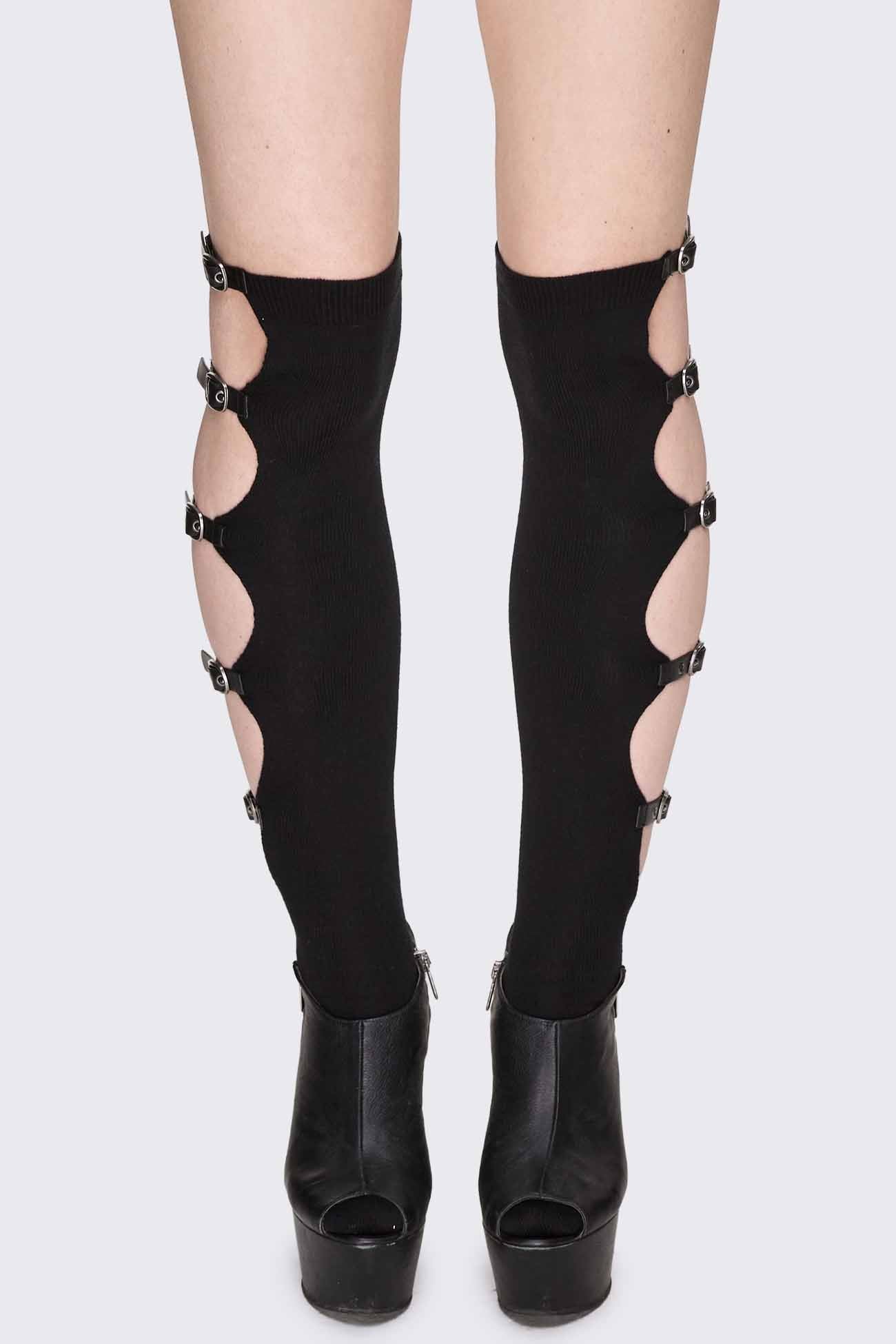 Black knee-high socks with side cut-outs, buckle straps, silver-tone hardware and ribbed cuffs.